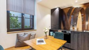 a kitchen with a wooden table and a dining room at Die Ferienwohnung in Reichenau