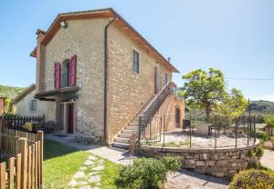 an old brick house with a fence around it at Podere del Pereto Bio- 202 in Rapolano Terme +17 photos