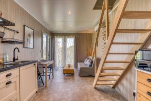 a kitchen with a staircase leading to a living room at Maison Greenkub in Générac