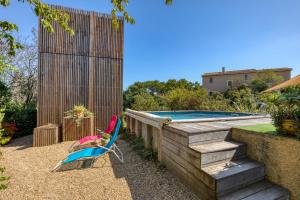 a yard with a chair and a swimming pool at Maison Greenkub in Générac