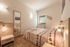 a bedroom with a bed and a mirror at Nonno Bigi Papavero in Tremosine Sul Garda