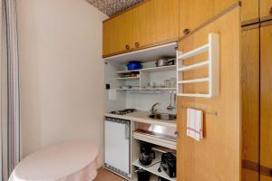 a small kitchen with a sink and a stove at Gästehaus Hirzel in Bad Wildbad +31 photos