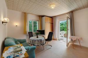 a living room with a couch and a table at Gästehaus Hirzel in Bad Wildbad