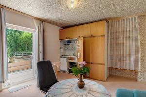 a living room with a table and a window at Gästehaus Hirzel in Bad Wildbad
