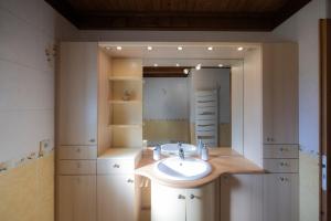 a bathroom with a sink and a mirror at Gîte La Clé Des Champs in Manigod +25 photos