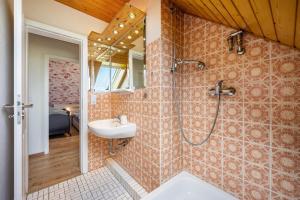 a bathroom with a shower and a sink at Ferienhaus Ostseetraum in Göhl +16 photos