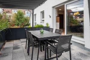 a black table and chairs on a patio at Fewo Ebringen Weinbergblick in Ebringen