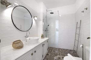 a white bathroom with a sink and a mirror at Lindo T2 com vista mar in Quarteira +17 photos