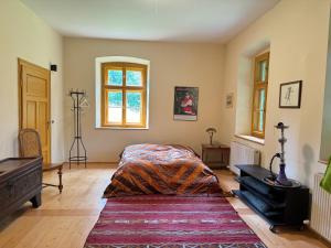 a bedroom with a bed and a piano and a window at Haus Tanegg in Innsbruck