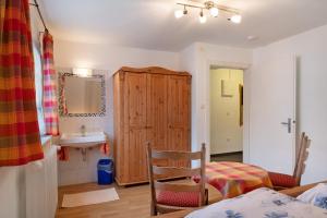 a bedroom with a sink and a cabinet and a bed at Haus Luise in Lenzkirch in Lenzkirch +68 photos