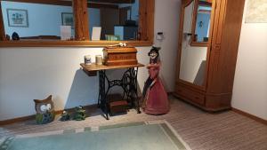 a room with a doll standing next to a table at Ferienwohnung Stell in Altenbrak +18 photos