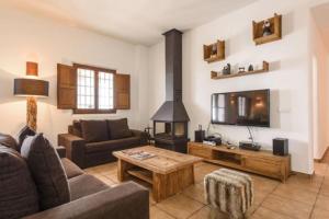 a living room with a couch and a fireplace at Villa Dalt S Era in Santa Gertrudis de Fruitera
