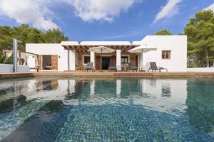 a villa with a swimming pool in front of a house at Villa Dalt S Era in Santa Gertrudis de Fruitera