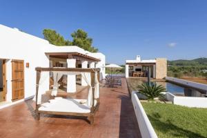 a patio with a hammock on top of a house at Villa Dalt S Era in Santa Gertrudis de Fruitera