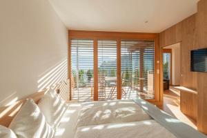 a bedroom with a bed and a large window at Moosbichlerhof in Marlengo +67 photos