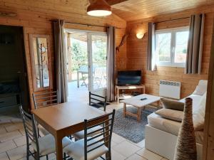 a living room with a table and a couch at La Petite Maison De Noémie in Gras