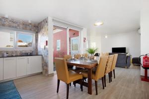 a dining room and kitchen with a table and chairs at Casa Davó in Leiria