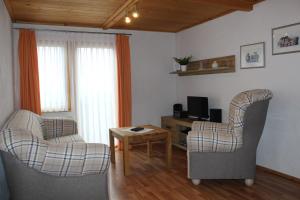 a living room with two chairs and a table at Äckerhof in Wolfach