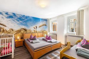 a bedroom with two beds and a crib at Ferienhaus Rodershausen in Rodershausen