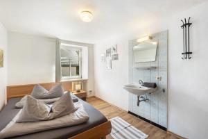 a bedroom with a bed and a sink at Ferienhaus Rodershausen in Rodershausen +37 photos