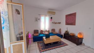 a living room with a couch and a table at Syros Mandala Studios in Megas Gialos - Nites
