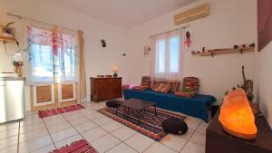 a living room with a couch and a table at Syros Mandala Studios in Megas Gialos - Nites