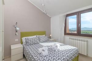 a bedroom with a bed and a window at C 306 Attico Puntavilla Mare in La Maddalena