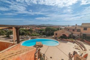 a view of a swimming pool from a house at C 306 Attico Puntavilla Mare in La Maddalena