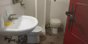 a bathroom with a white sink and a toilet at Antico Dammuso Invernale in Pantelleria