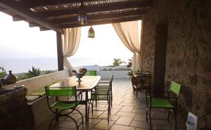 a dining room with a table and chairs at Antico Dammuso Invernale in Pantelleria