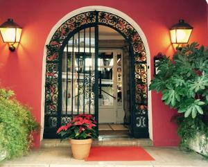an entrance to a red house with a black door at Grand Hôtel de la Poste in Saint-Jean-de-Luz