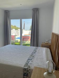 a bedroom with a bed and a view of a pool at Villa Gracia in Mijas +36 photos