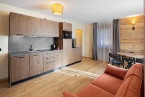 a kitchen and living room with a couch and a table at Villa Elma - Livigno in Livigno