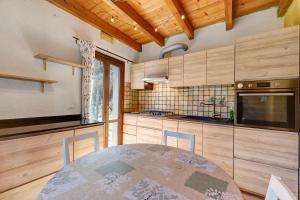 a kitchen with a table and some wooden cabinets at Del Fiume in Rialto