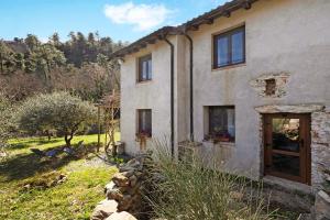 a stone house with windows and a yard at Del Fiume in Rialto