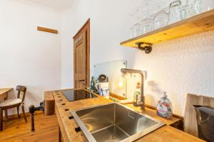 a kitchen with a sink and a counter at Apartment zur alten Post in Ulrichstein