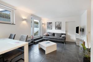 a living room with a couch and a table at Goldbecker in Gaienhofen