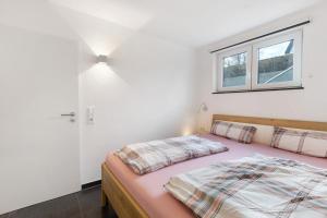 a bedroom with two beds and a window at Goldbecker in Gaienhofen