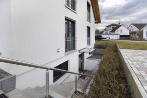a stairway leading to a white building with a window at Goldbecker in Gaienhofen