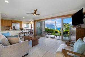 a living room with a couch and a tv and a kitchen at Ocean Bluff Gem in Princeville Beach Access Pool in Princeville +43 photos