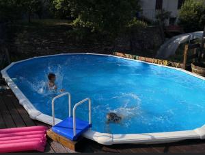 two children playing in a large swimming pool at Antico Granaio in Vessalico