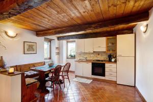 a kitchen with a table and chairs in a room at Antico Granaio in Vessalico