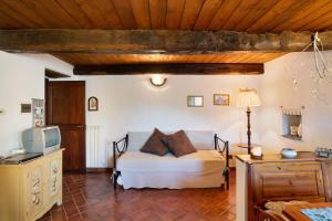 a bedroom with a bed and a tv in a room at Antico Granaio in Vessalico