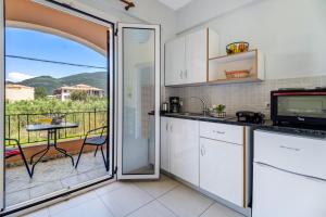 a kitchen with a view of a balcony at Studio Phaethon in Póndi