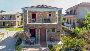 an external view of a house with a table and chairs at Mirage Arillas Honeymoon Studio in Arillas +13 photos