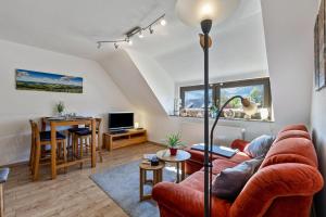 a living room with a couch and a table at Ferienwohnung im Elsetal in Plettenberg