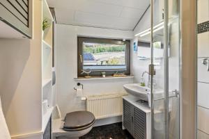 a bathroom with a toilet and a sink at Ferienwohnung im Elsetal in Plettenberg +19 photos