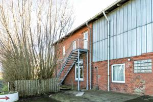 a brick building with a staircase on the side of it at Gutgemacht in Sankt Annen