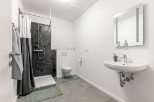 a white bathroom with a sink and a toilet at Gutgemacht in Sankt Annen
