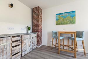 a dining room with a table and chairs and a brick wall at Gutgemacht in Sankt Annen +33 photos